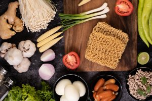 Noodles arranged with fresh ingredients around them, highlighting key components.