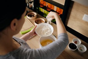 Person cooking noodles at home in a kitchen setting.